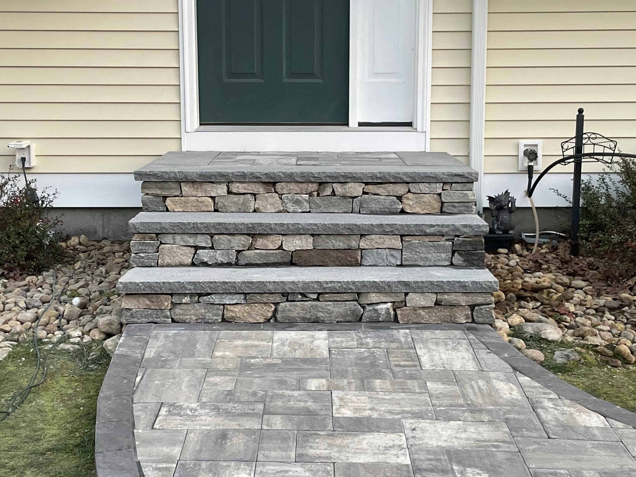 Natural stone steps and paver walkway at a front entry